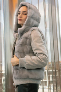 Reversible mink bomber jacket with hood with dropped sleeves, wool cuffs and hem. Zip fastening. Inside pockets with zip