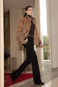 Short beige mink jacket with wide high collar. Hooks fastening and a magnet on the  collar. Long sleeves. Slim fit style