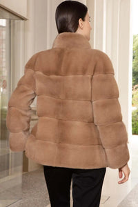 Short beige mink jacket with wide high collar. Hooks fastening and a magnet on the  collar. Long sleeves. Slim fit style
