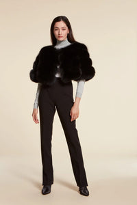 Short elegant black fox fur jacket with round collar and fastening with hooks. Short sleeves.Very young and glamorous