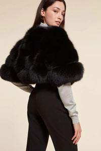 Short elegant black fox fur jacket with round collar and fastening with hooks. Short sleeves.Very young and glamorous