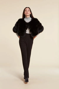 Short elegant black fox fur jacket with round collar neck and fastening with hooks. Short sleeves.Very young and glamorous