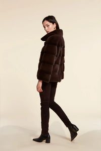 Short brown mink jacket with wide collar and long sleeves. Concealed vertical pockets and fastening with fur hooks