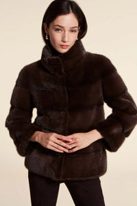 Short brown mink jacket with wide collar and long sleeves. Concealed vertical pockets and fastening with fur hooks