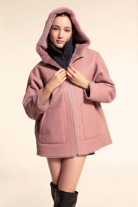 Ladies shearling jacket with over-sized line and large hood. Dropped shoulder set-in sleeves. Zip fastening. Drawstring hood