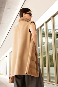 Cashmere knee-length mink vest for women. Shawl collar, concealed pockets, straight bottom and closure with fur hooks 